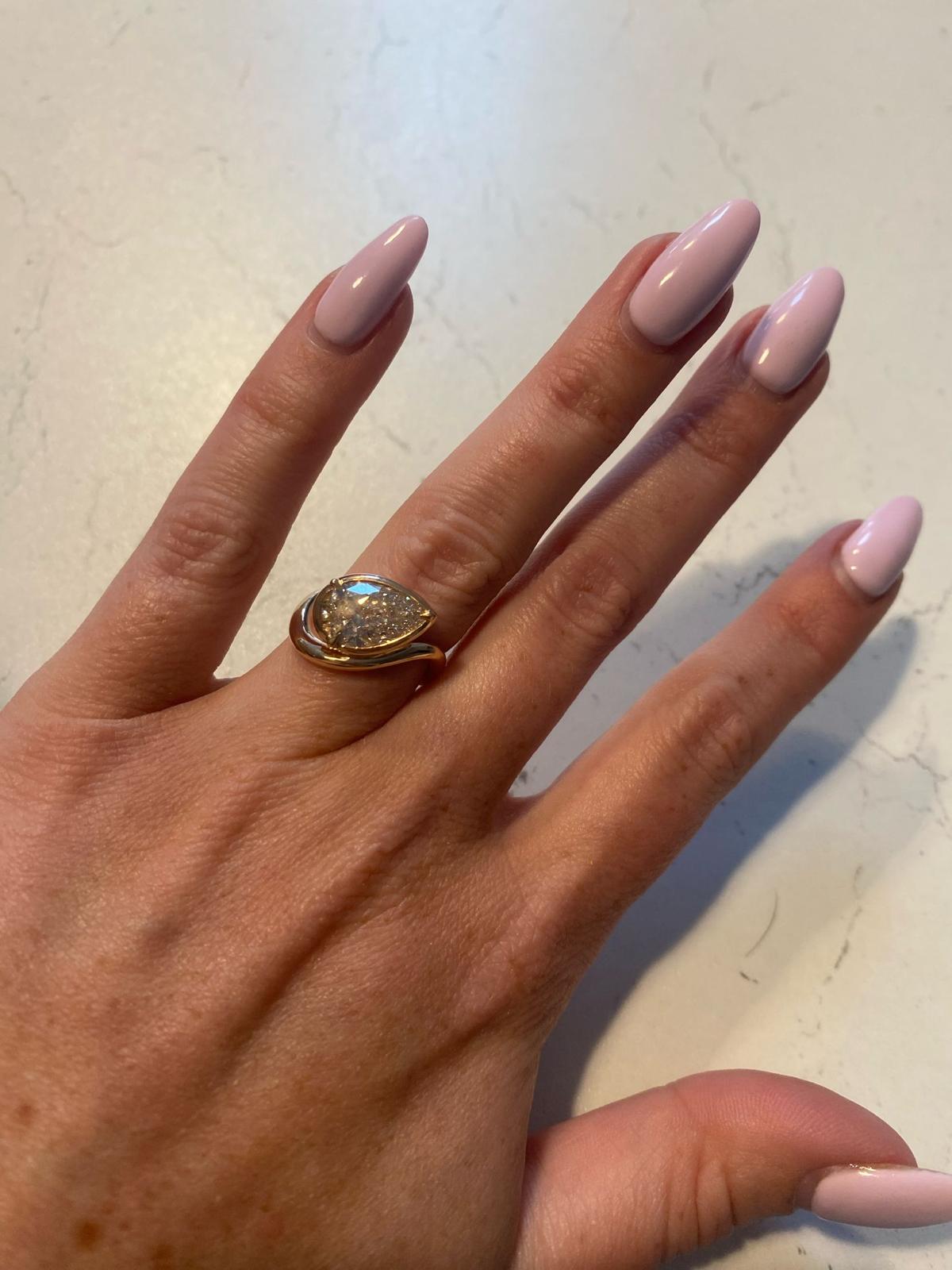 Jo McFadden wearing her finished bespoke pear-cut engagement ring